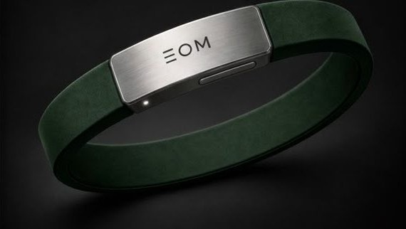 Concept render of the EOM bracelet: a green band with a silver-coloured top showing the EOM mark